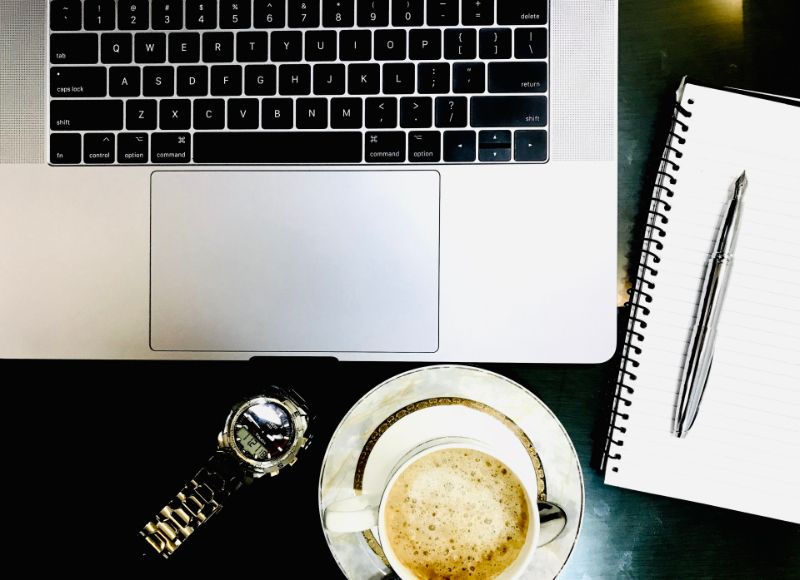 Workspace with laptop, notebook and coffee